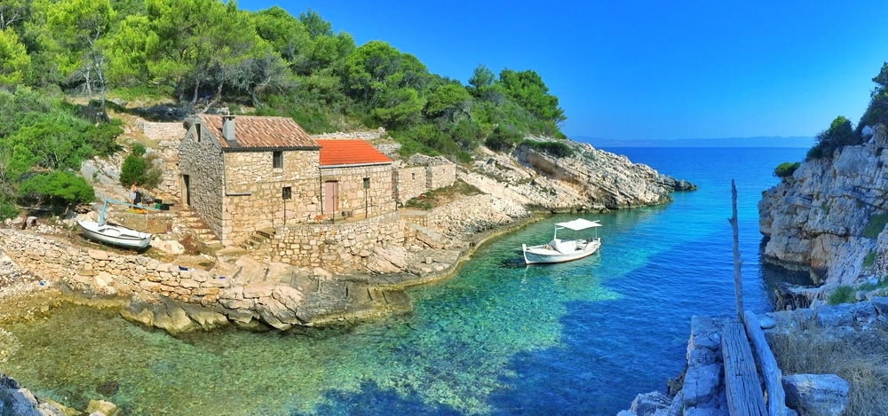 Remote,Bay,With,Old,Stone,Houses,And,Old,Fishing,Boat